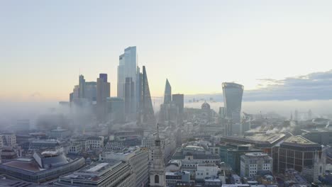 Establishing-aerial-slider-shot-of-London-Central-business-district-foggy-sunrise