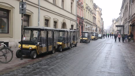 Sightseeing-electric-cars-Melex-parked-on-Slawkowska-Street,-Krakow-Poland