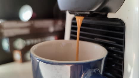 Cremiger-Kaffee-In-Zeitlupe,-Der-Auf-Eine-Blaue-Tasse-Gegossen-Wird