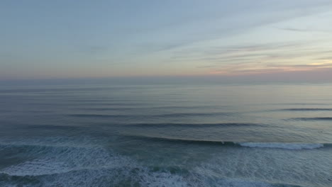 Horizon-shot-at-sunset-with-waves-and-surfers-on-the-frame