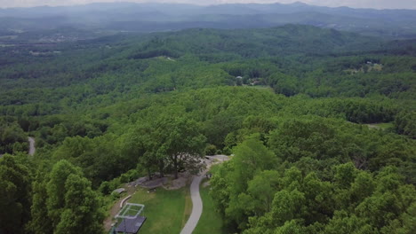 Aerial-reveal-of-North-Carolina-forests-from-Jump-Off-Rock,-near-Hendersonville