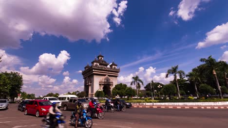 Patuxai-monument-Vientiane-with-fluffy-clouds-and-city-traffic