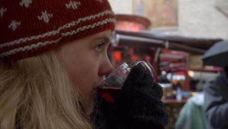 Slow-motion-shot:-Blonde-woman-drinking-a-cup-of-gluhwein