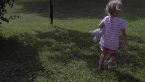 cute-girl-running-into-frame-and-running-out-of-frame,-copy-space,-grass-field-in-summer,-slow-motion