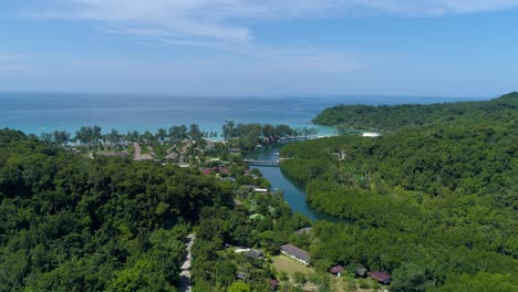 Drone-shot-of-estuary-on-tropical-island-with-resorts-on-the-beach