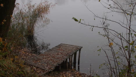 A-small-wooden-pier-on-a-lake-during-a-foggy-misty-morning