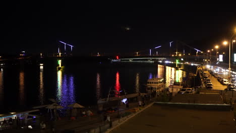 Illuminated-Parkovyi-bridge-over-Dnieper-river-at-night