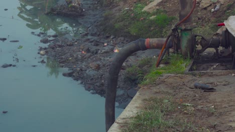 sewerage-water-suction-pipe-and-motor,-Suction-pipe-dip-in-the-sewerage-water,-dirty-tap