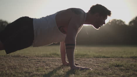 Man-Doing-Press-Ups-In-The-Park-In-The-Evening-Sun---Ungraded