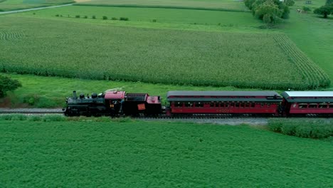 Steam-Train-Puffing-Along-Amish-Farmlands-as-Seen-by-Drone