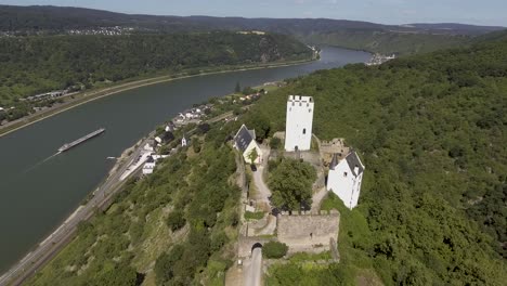 Drone-flight-close-to-an-old-castle-on-a-mountain-above-a-german-village