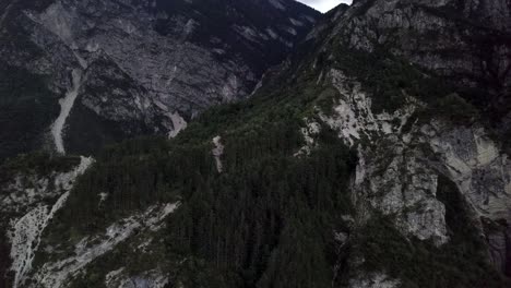 Aerial-view-of-the-mountains-and-forest-in-Borgo-Valsugana-in-Trentino-Italy-with-drone-flying-down