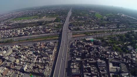 Aerial-view-over-the-City-traffic-road-junction-and-canal,-bridge-highway
