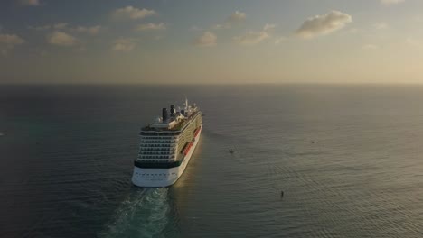 Aerial-view-of-the-cruise-ship-sailing-into-the-big-blue-ocean-4K