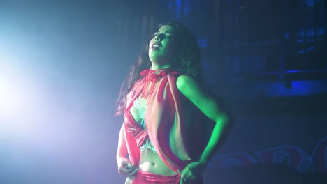 Sensual-belly-dancer-with-scarves-performing-on-stage