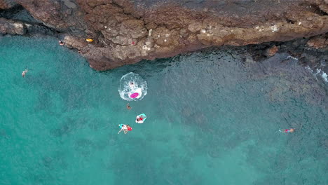 Drone-Footage-of-a-guy-cliff-jumping-onto-a-raft
