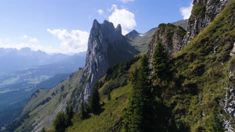 massive-rock-formation-in-the-swiss-alps,-unique-mountain-at-a-sunny-summer-day-with-green-meadow,-saxer-lucke-alpstein