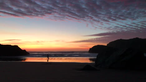 Person-jogging-and-staying-fit,-running-at-sunset-at-an-Oregon-coast-beach