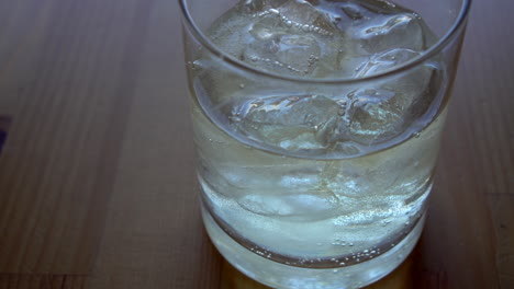 Extreme-close-up-of-a-Bartender-making-a-long-drink-with-tequila-and-tonic-water