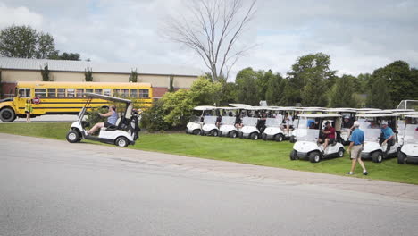 Line-up-of-golf-carts-driving-off-to-start-the-tournament