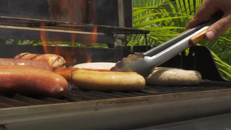 BBQ-Sunny-Day-Sausages-Grilled-Food-Men-laying-out-sausages-on-the-bbq-Fire-raw-cooking