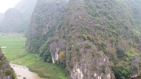 Aerial-of-river-between-limestone-karsts-near-Trang-Ang
