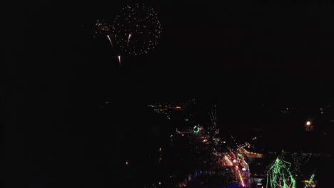Aerial-flight-above-dance-festival-on-tropical-island-beach-with-colorful-Fireworks