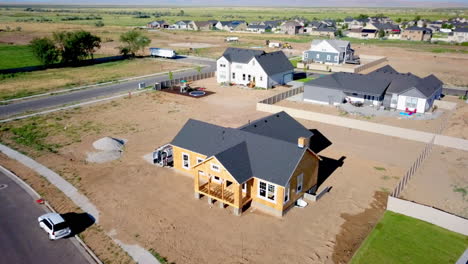 A-drone-shot-floating-around-a-newly-built-home-with-it’s-walls-and-roof-barely-placed