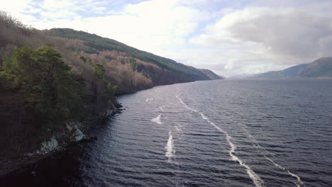Aerial-footage-of-Loch-Ness-looking-towards-Fort-Augustus-on-a-sunny-day,-Scottish-Highlands,-Scotland