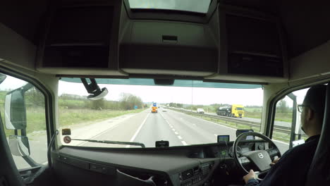 In-cab-view-of-a-HGV-driver-on-the-M6-motorway-using-the-slip-road-to-join-the-M1