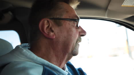 Close-up-of-man's-face-while-driving-his-car