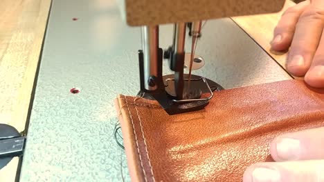 Clip-of-a-man-sewing-a-piece-of-leather-with-an-industrial-walking-foot-sewing-machine
