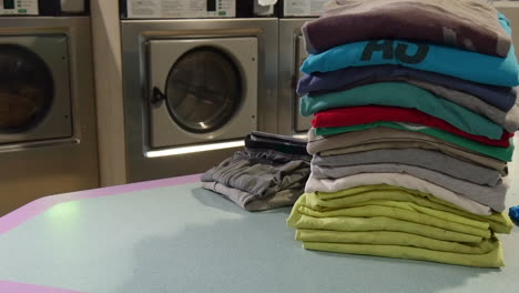 folded-clothing-on-laundromat-counter
