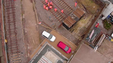 Drone-shot-Aerial-Liverpool-railway-builders-performing-construction-on-national-railway-tracks-for-the-train-service
