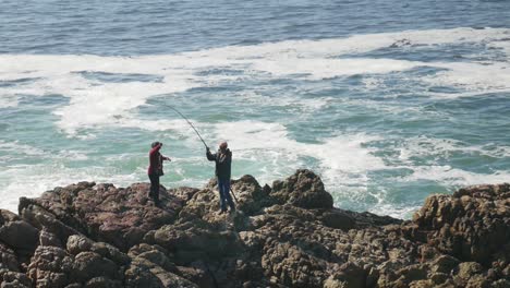 Local-fisherman-catches-and-lands-fish-on-rocks-from-the-ocean