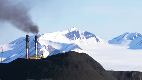 A-powerful-contrast-of-a-coal-power-plant-in-front-of-a-white-glacier-in-Barentsburg,-Svalbard-in-the-Arctic
