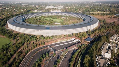 Aerial,-rising,-drone-shot,-of-Apple-Park-building,-on-a-sunny-day,-Cupertino,-California