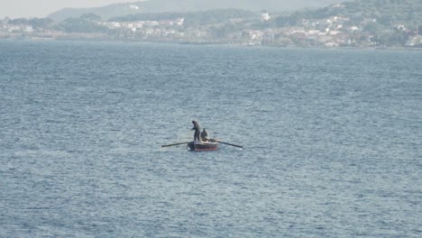 Slow-Motion-Shot-of-a-Fisherman-Pulling-in-a-Fishing-Net