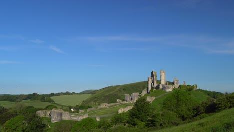 Pan-and-zoon-shot-of-Corfe-Castle-in-early-morning-light,-Isle-of-Purbeck,-Dorset,-England