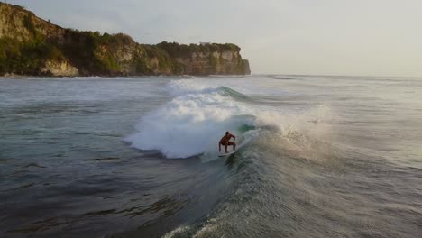 Surfer-during-sunset-at-the-famous-surf-spot-Uluwati-in-Bali