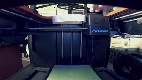 Fish-eye-view-of-blue-PLA-filament-being-added-to-a-3D-printer