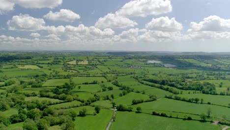 Picturesque-aerial-of-glorious-green-English-fields-against-a-blue-sky-and-perfect-clouds