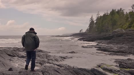 Vancouver-Island-west-coast-shoreline-at-Port-Renfrew-with-man-looking-at-waves