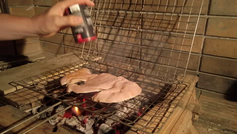 Slow-Motion-Shot-of-Man-Adding-Seasoning-to-Grilled-Chicken-on-a-Charcoal-BBQ-at-Night