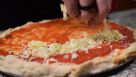 Chef-putting-mozzarella-chef-on-a-pizza-in-slow-motion