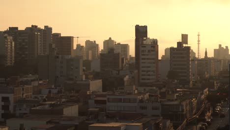 Lovely-view-of-cityscape-of-Lima-during-beautiful-orange-sunset,-Peru