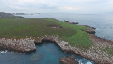 Aerial-pull-back-shot-of-the-Isla-Redonda-with-the-famous-hidden-beach,-Marietas-Islands,-Nayarit,-Mexico
