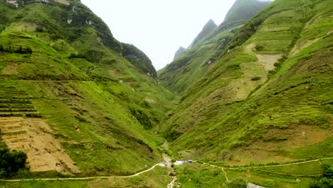 Aerial-descending-reveal-of-a-deep-lush-green-valley-in-the-mountains-of-northern-Vietnam