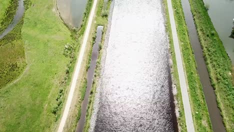 top-down-view-of-the-canal-and-pathway-with-sunlight-shines-the-water