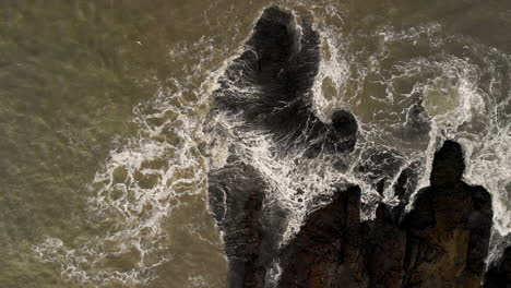 Aerial-Rising-Shot,-waves-on-rocks-coastline